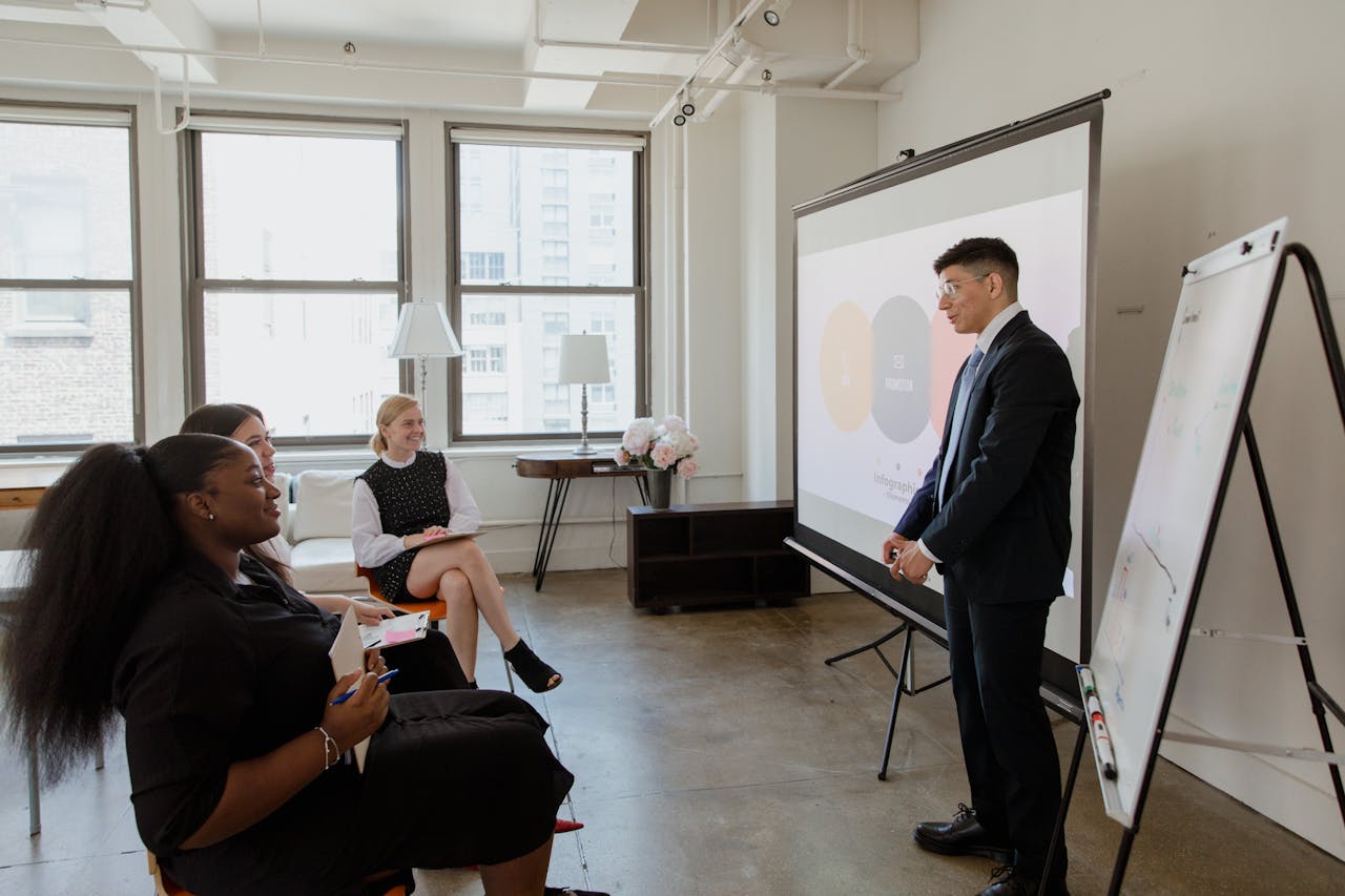 Professional business meeting with diverse team in a modern office setting.
